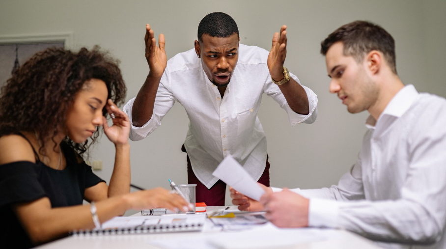 an angry boss yelling at employees